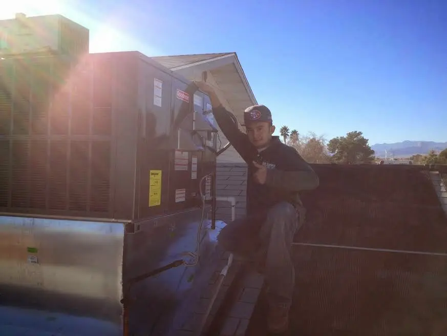 HVAC technician performing Boiler Repair on a rooftop unit in Spring